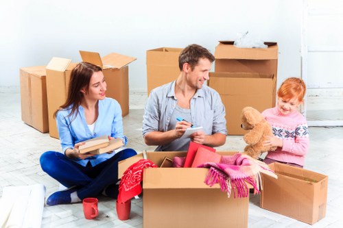 Same day removals team handling furniture in Holland Park