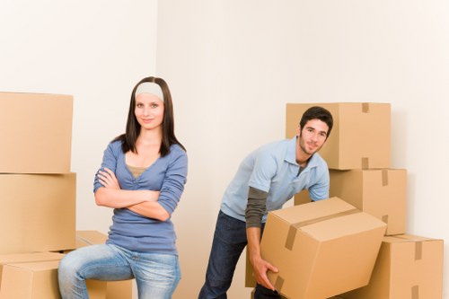 Removal crew transporting bulky items and boxes for an urgent move